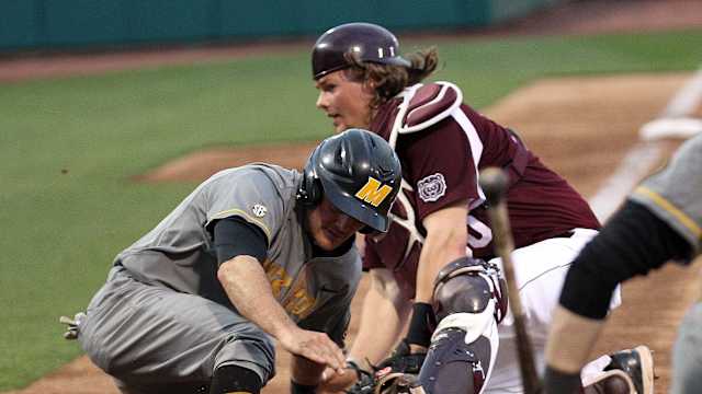 Mizzou's Dillion Everett slides past Missouri State catcher Luke Voit on Tuesday night at Hammons Field.